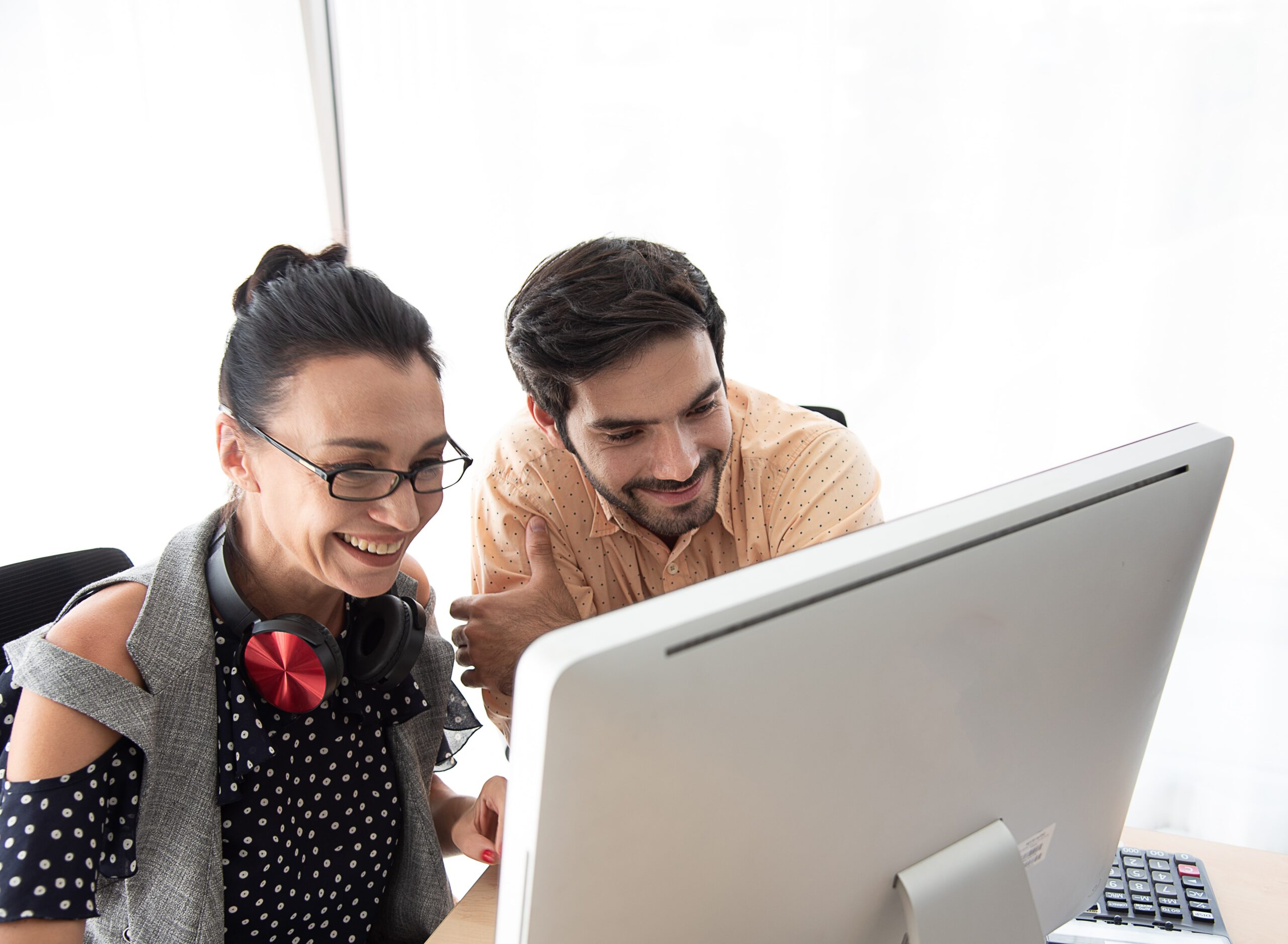 son-and-mother-look-at-computer-and-smile