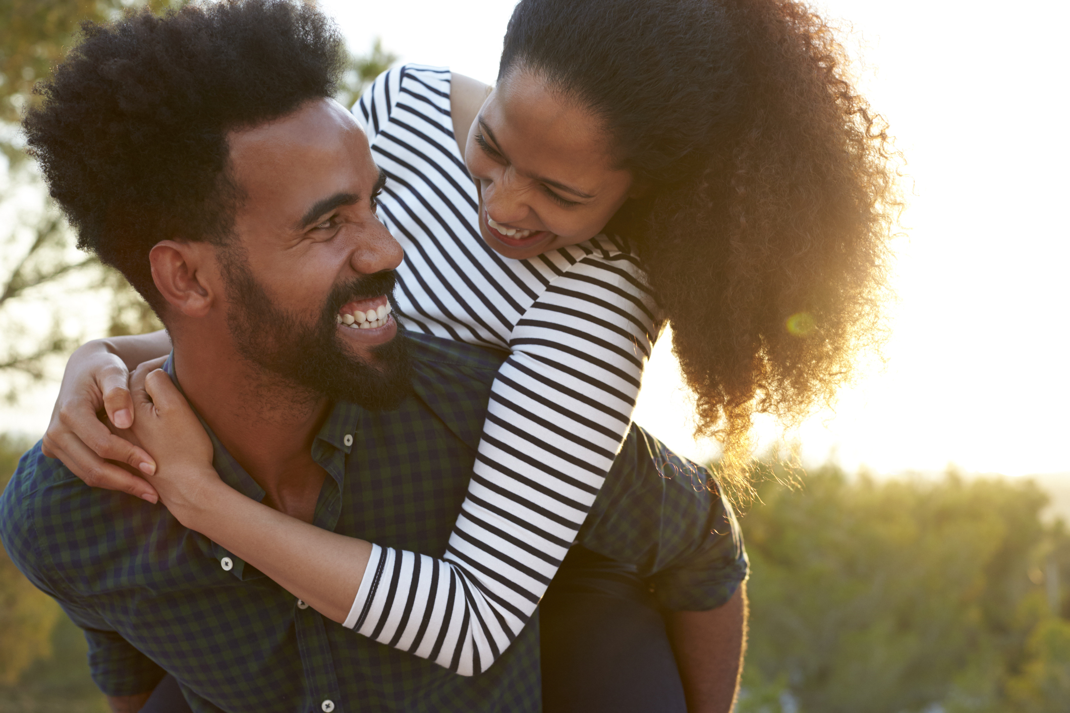 Man carrying young woman on his shoulders
